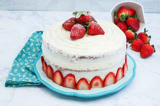 Strawberry Surprise Cake decorated with strawberries.