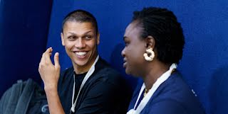 One man looking toward a women and smiling.