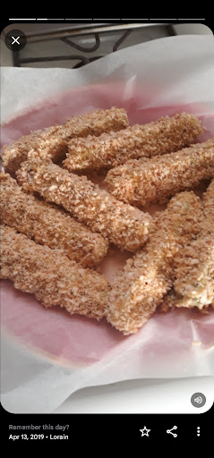 Pickles covered in a bed of breadcrumbs 