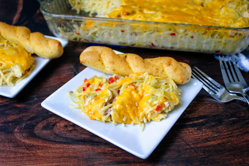 Chicken Spaghetti on a plate with garlic bread.