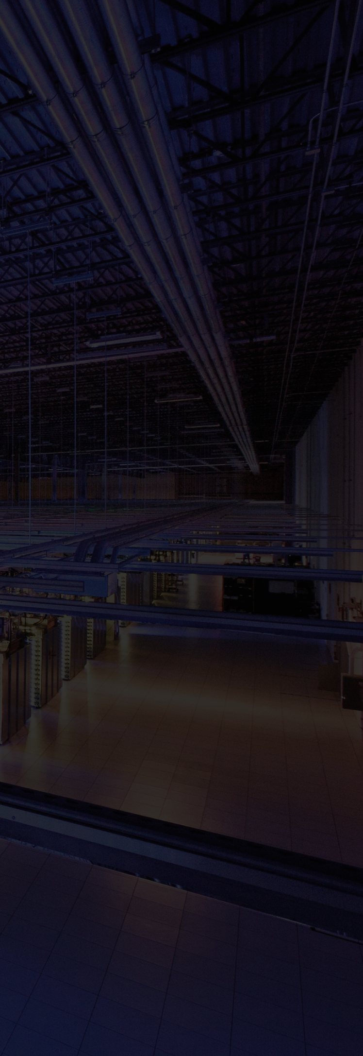 Interior of a data centre with rows of illuminated server racks.